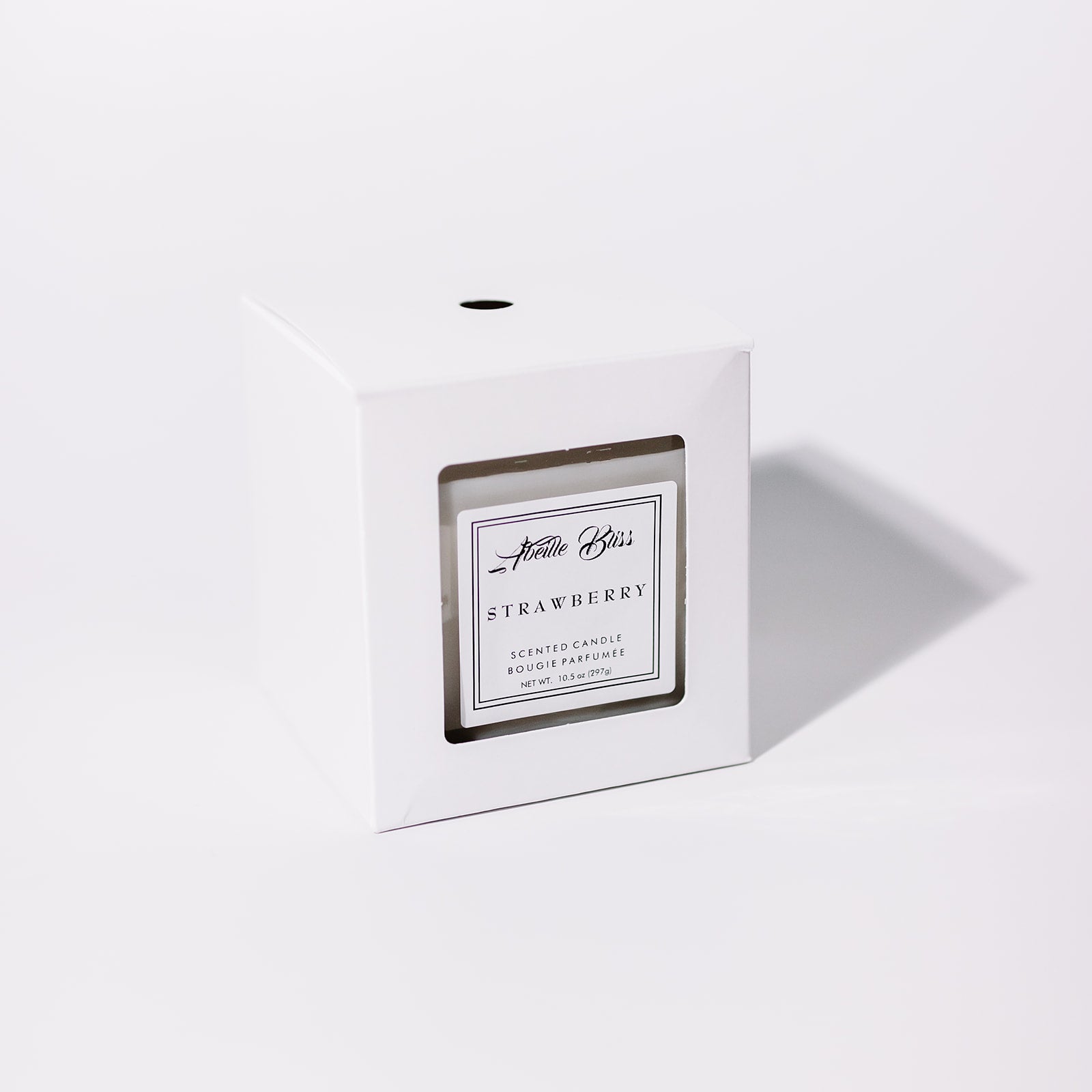 Strawberry fruity candle in its white classic box.
